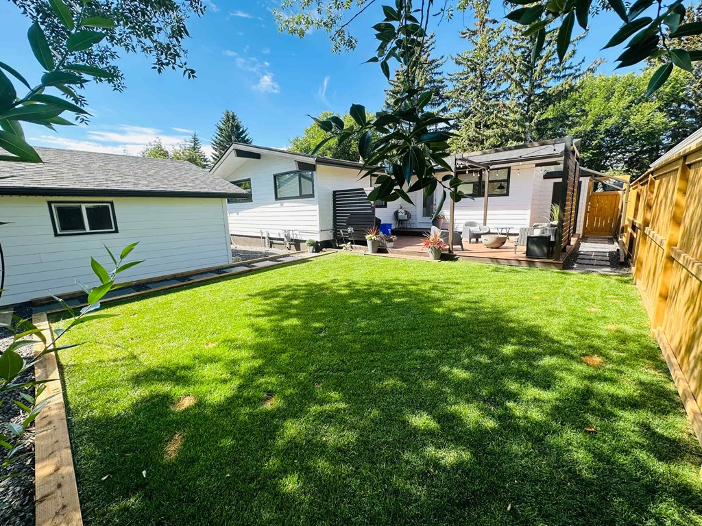 a backyard with a house and a yard with grass