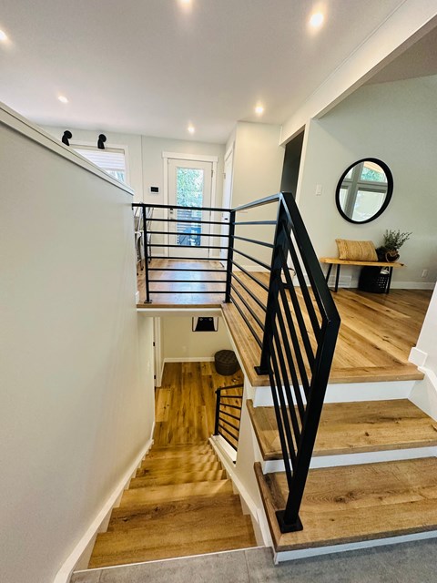 a staircase in a home with wood floors and white walls