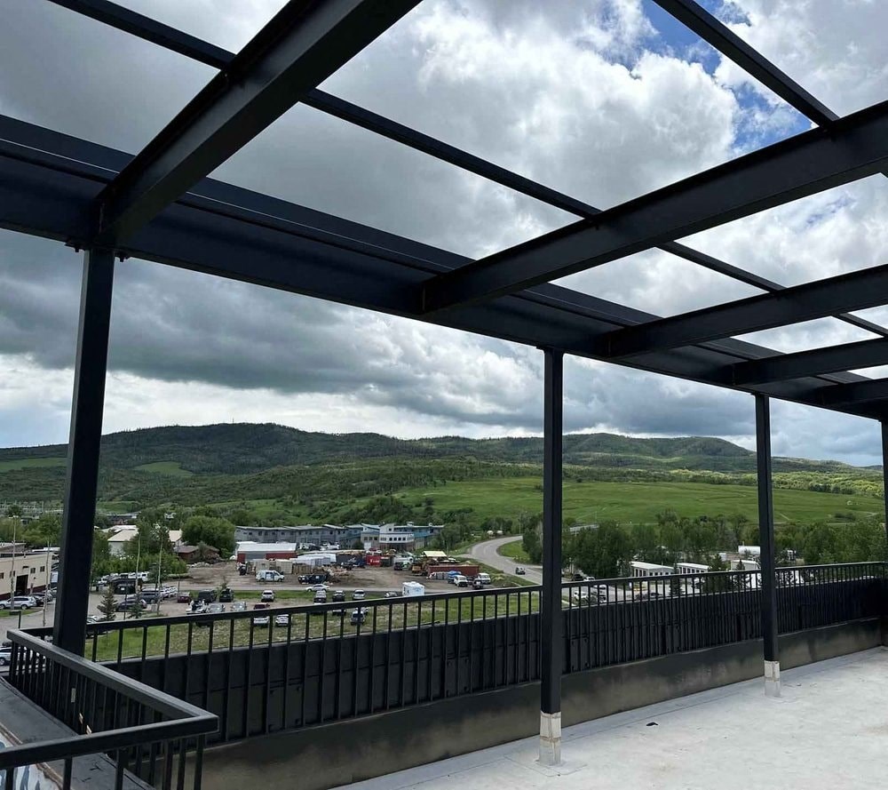 a view of a city from a balcony overlooking the mountains