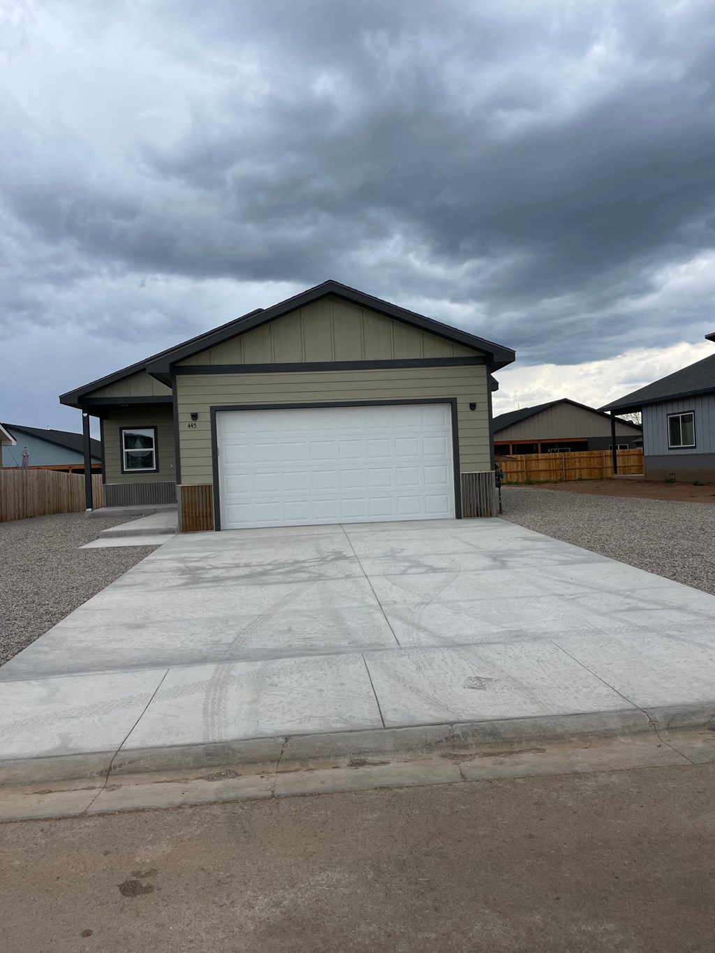 a concrete driveway in front of a house