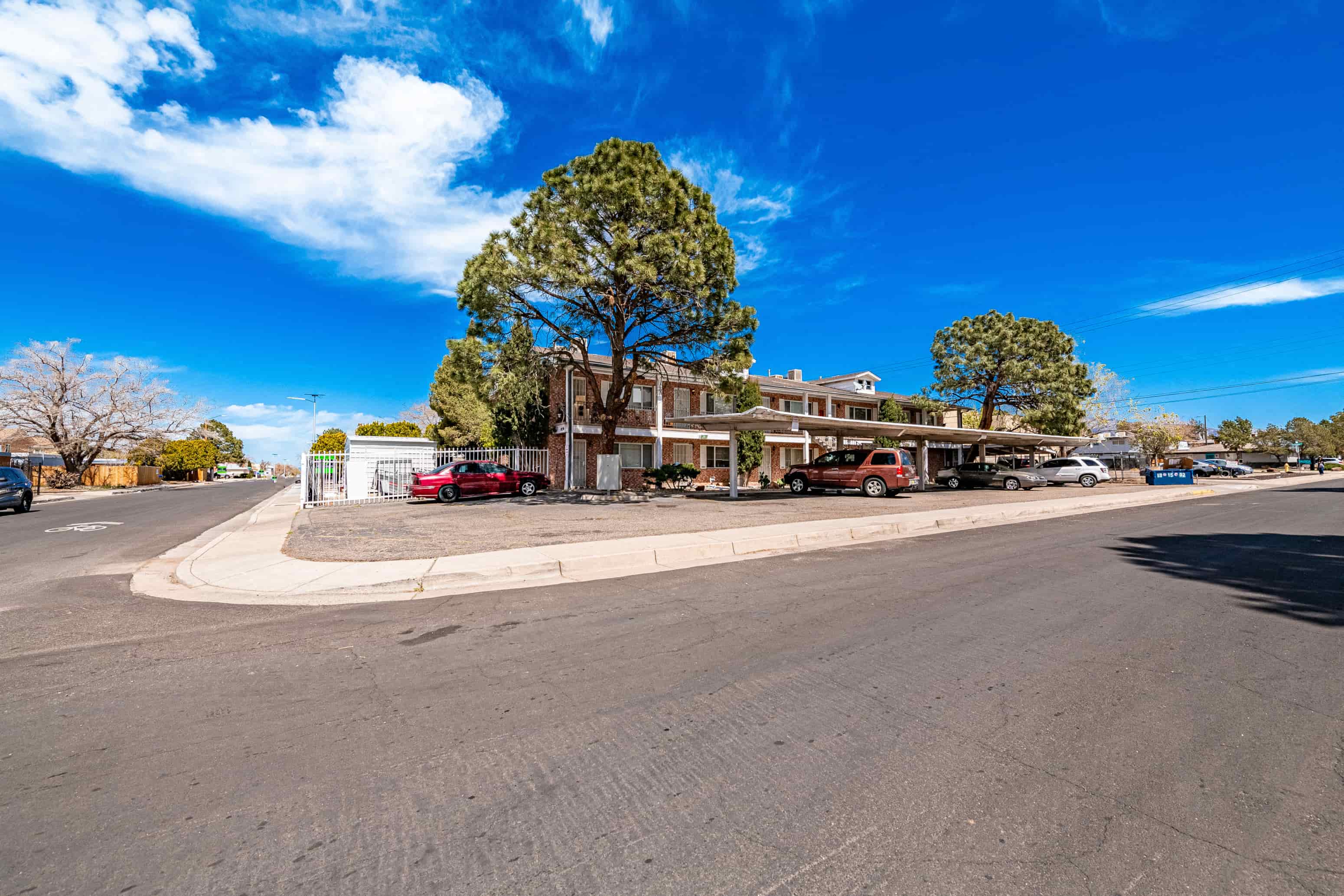 an empty street with a building on the corner of a street