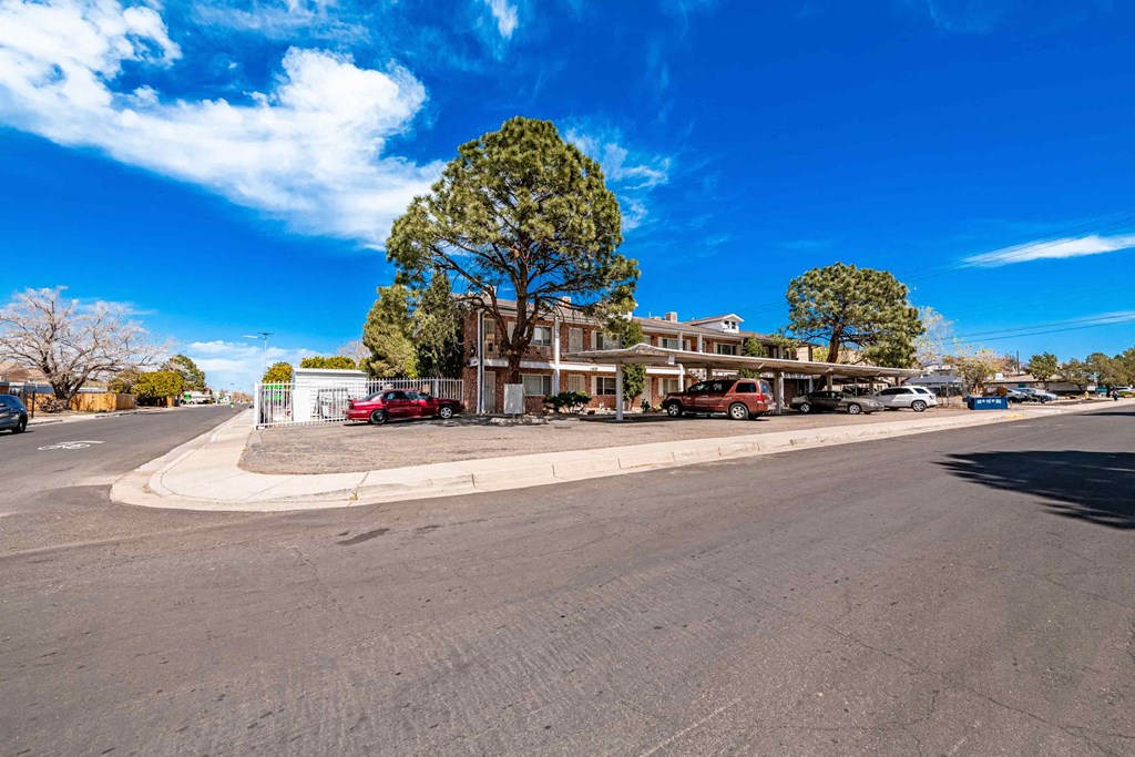 an empty street with a building on the corner of a street