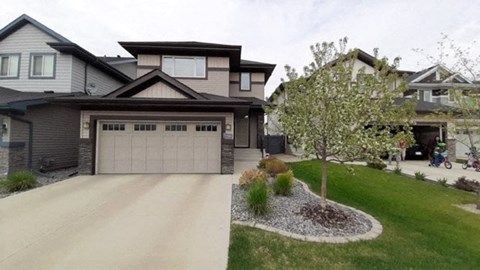 a house with a driveway and a garage door