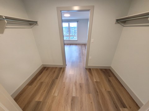 A room with wooden flooring and white walls.