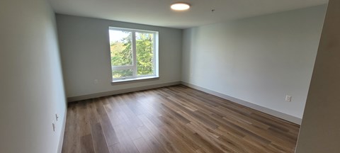 A room with wooden floors and a window.