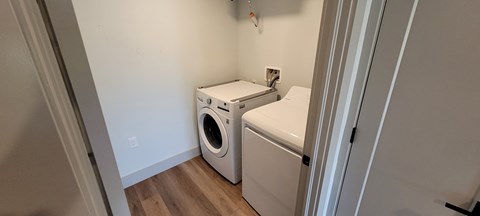A small laundry room with a washer and dryer.