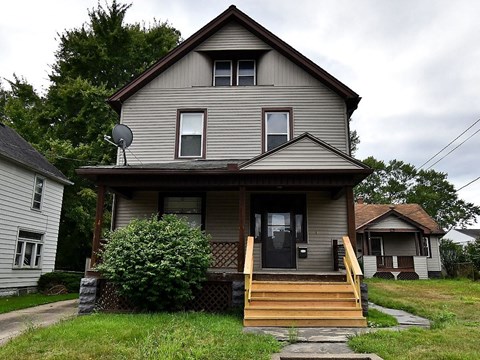 a house with a wooden porch and stairs