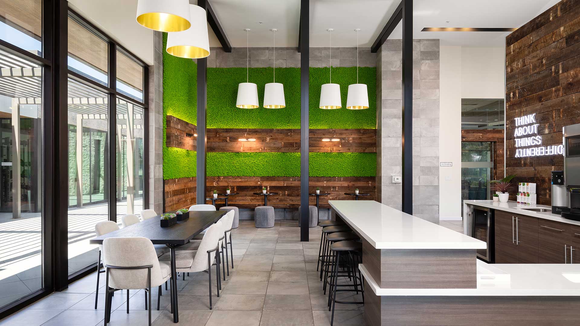 A modern lounge area with green walls and wooden accents.