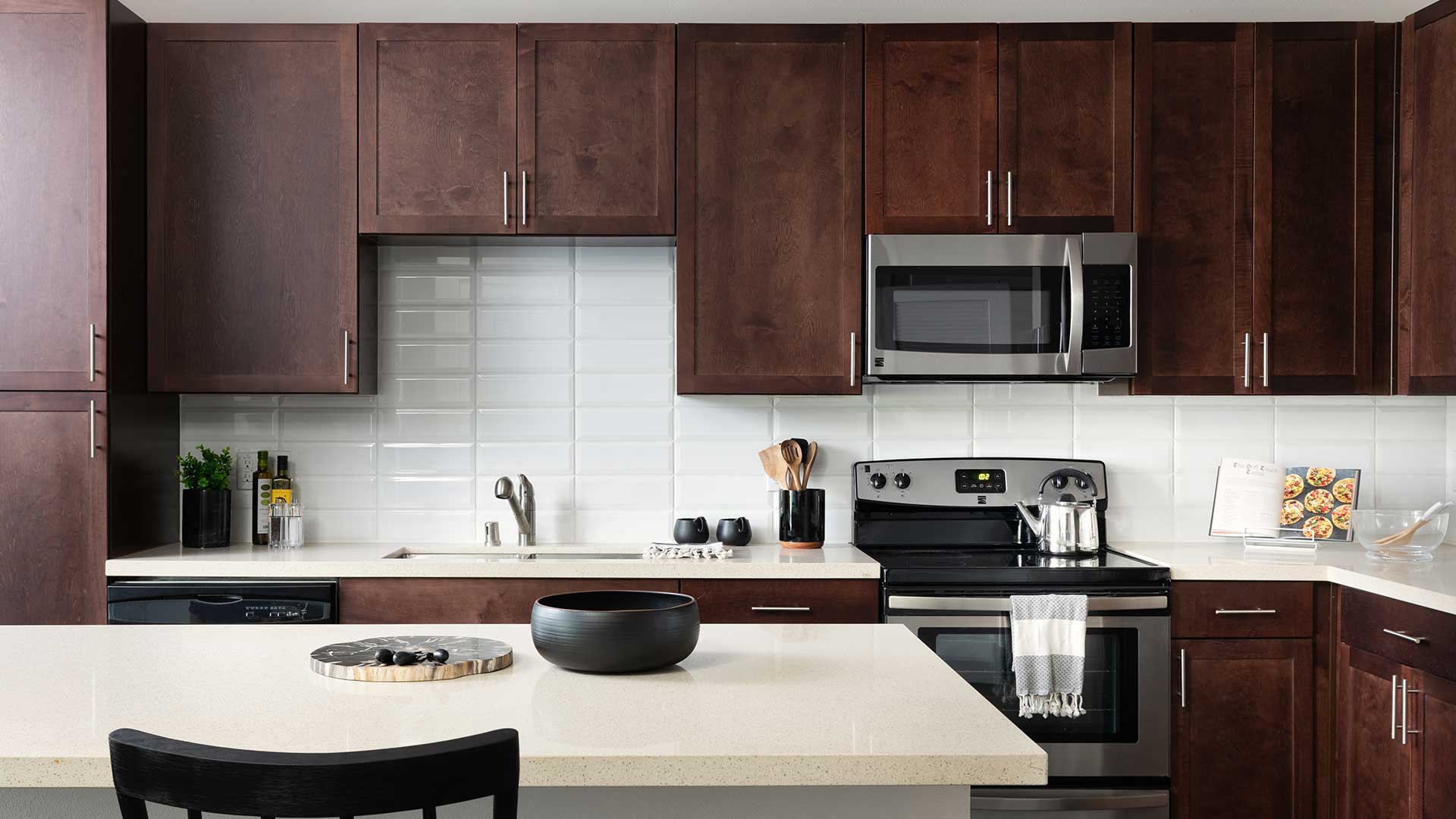 A kitchen with brown cabinets and stainless steel appliances.