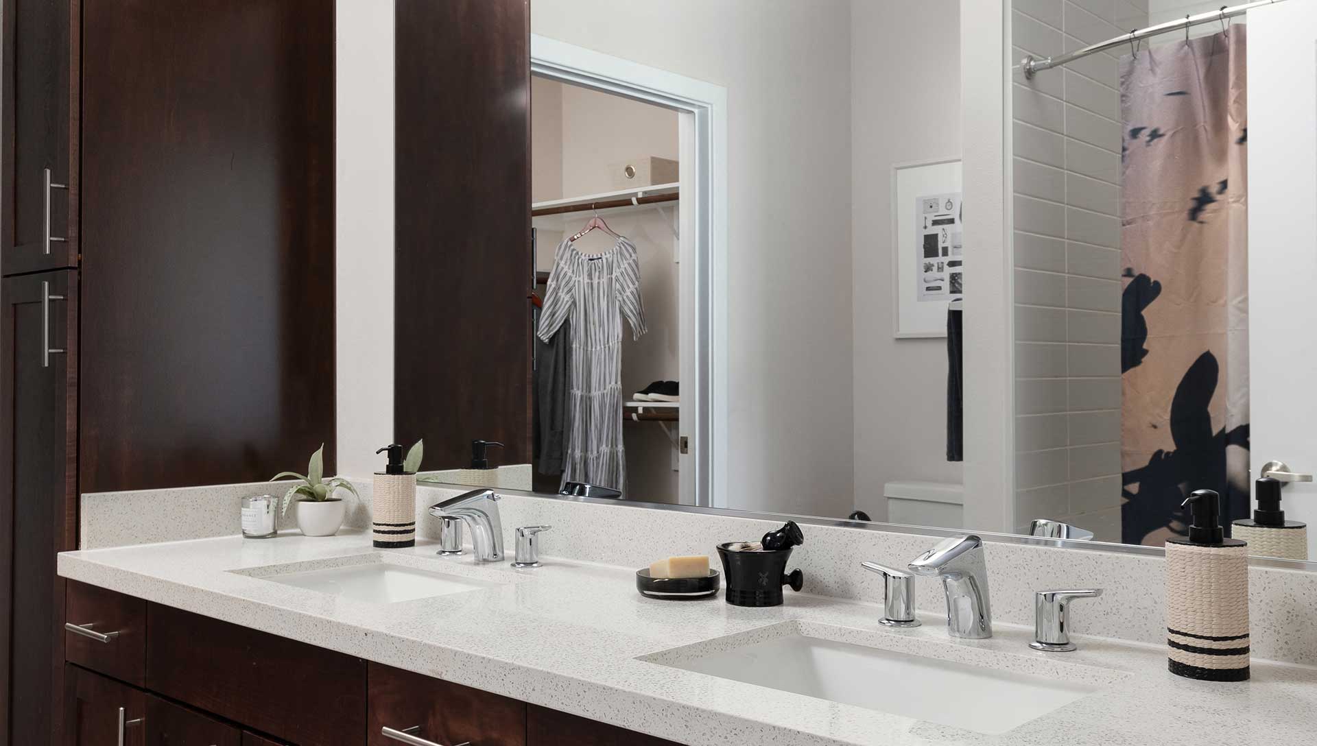 A bathroom with two sinks and a mirror.