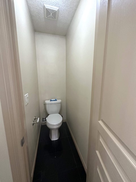 a small bathroom with a toilet and a door