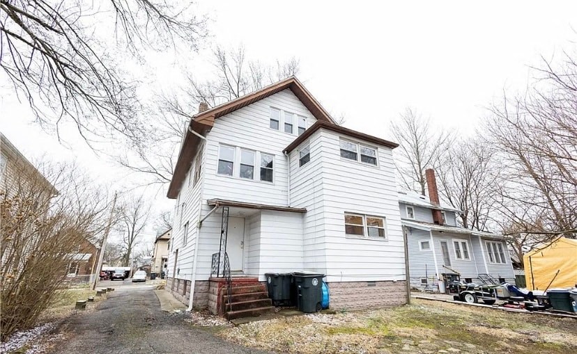 a white house on the side of a street