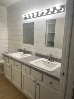 a white bathroom with two sinks and a mirror
