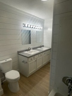 a white bathroom with a toilet and a sink