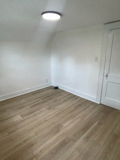 an empty room with white walls and a wooden floor