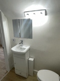 a white bathroom with a sink and a toilet