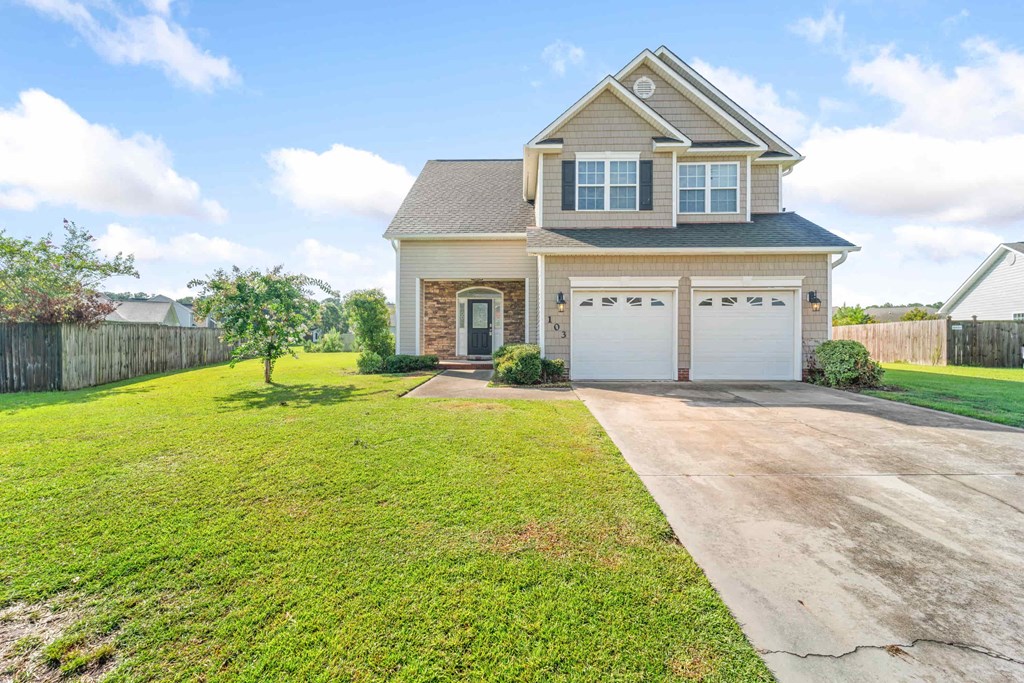 a house with a driveway and a garage door