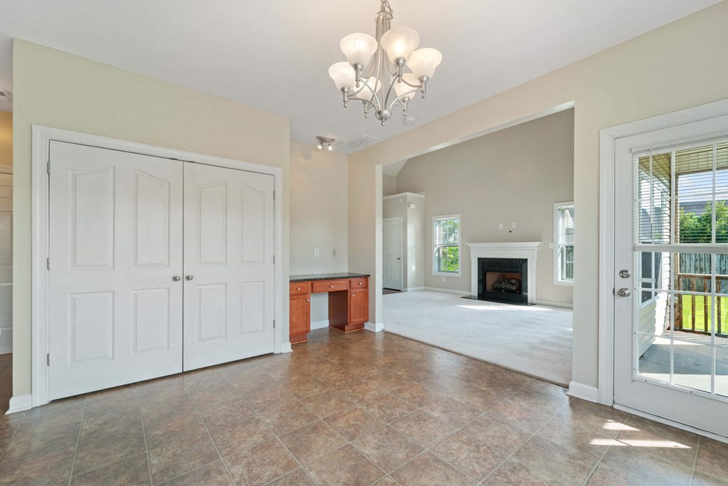 a large living room with a white door and a fireplace