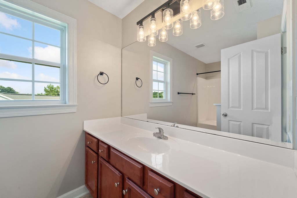 a bathroom with a large mirror and a sink