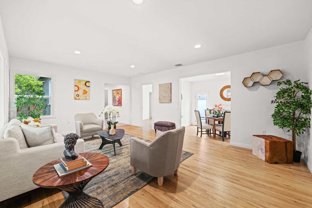 a living room with a couch and chairs and a table