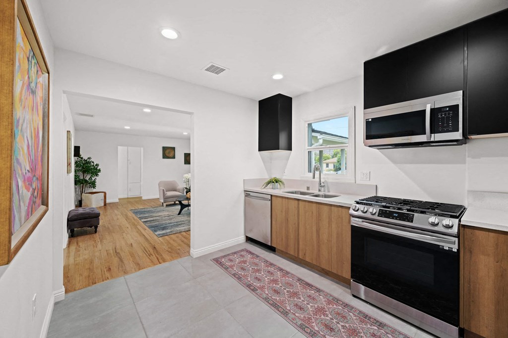 a kitchen with a stove top oven and a microwave