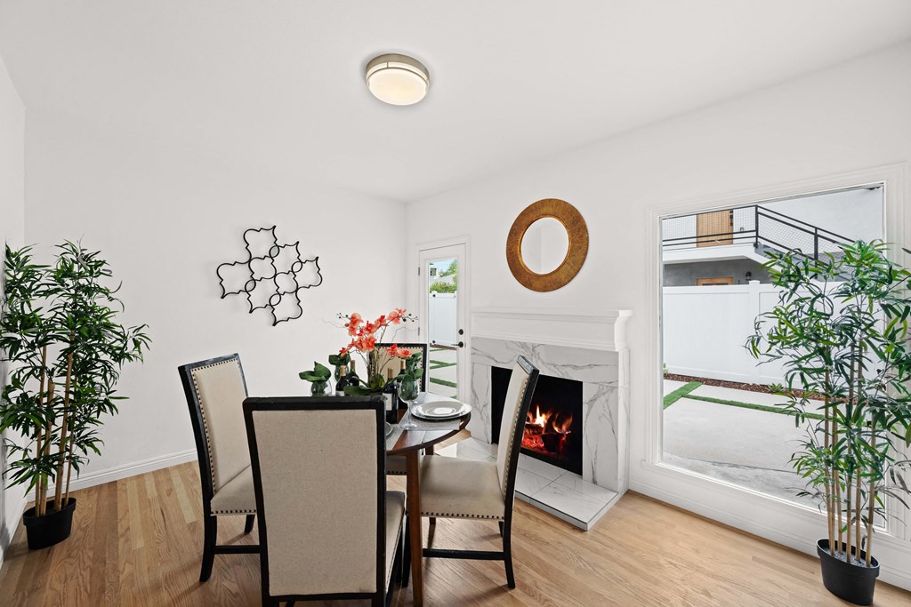 a dining room with a table and chairs next to a fireplace
