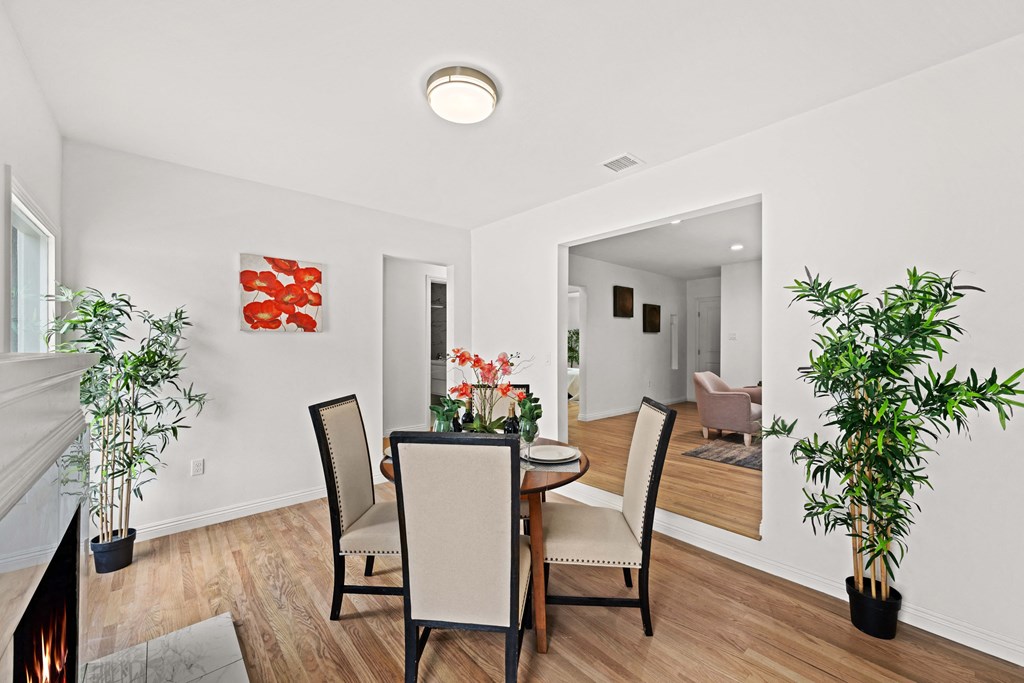 a dining room with a table and chairs and a fireplace