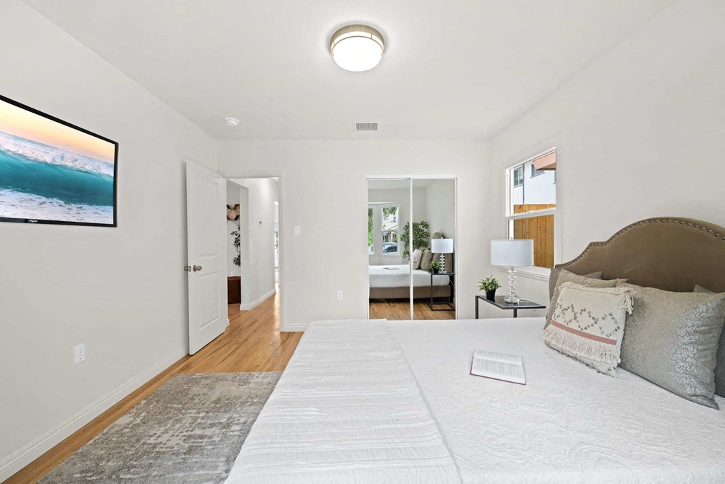 a bedroom with a bed and a door to a bathroom