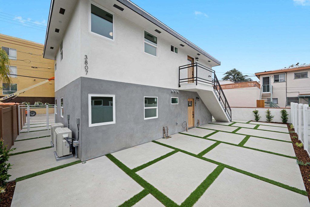 a gray house with a yard with green grass