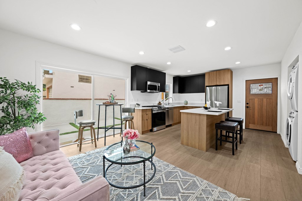 a living area with a kitchen and a couch and a table