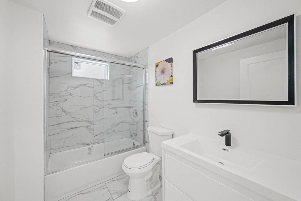 a bathroom with a sink toilet and a shower