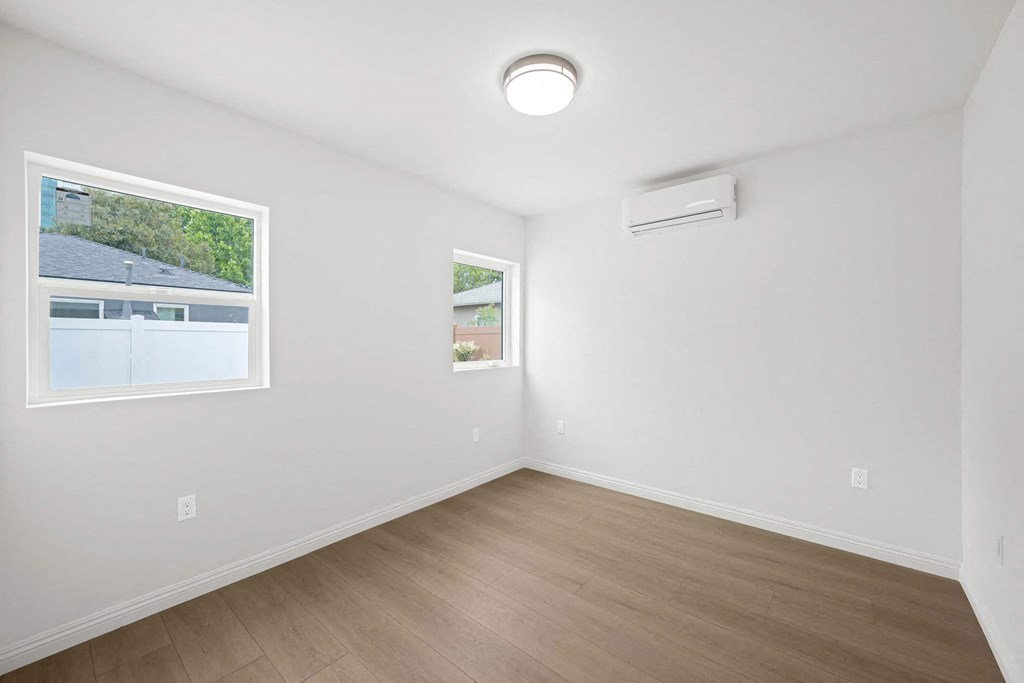 a living room with white walls and a window