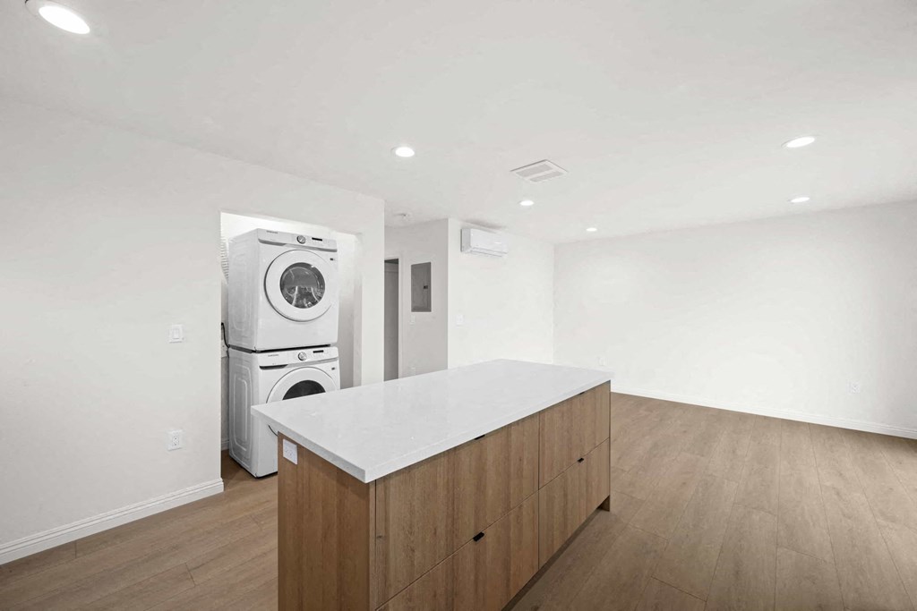a kitchen with a counter top and a washer and dryer