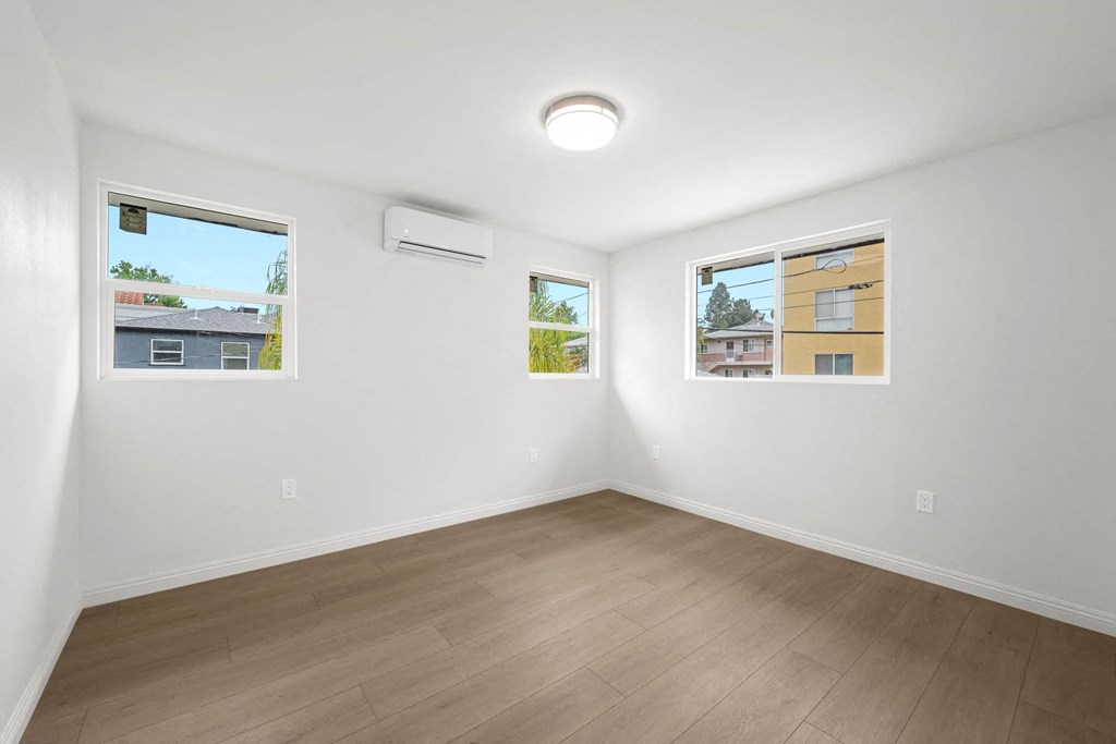 a living room with white walls and wood floors
