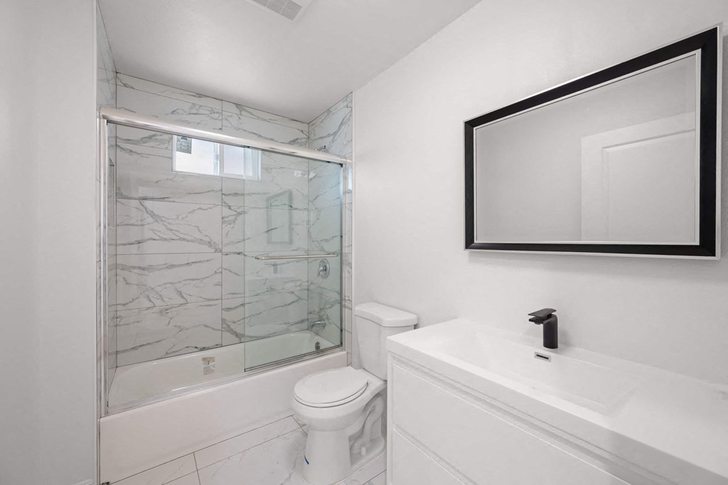 a bathroom with a sink toilet and a shower