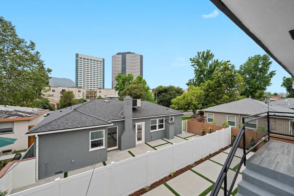 the view from the balcony of a house with skyscrapers in the background