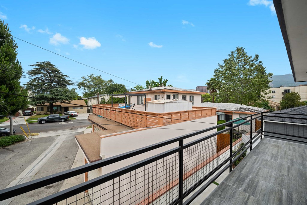 a view of a building from a balcony with a wooden deck