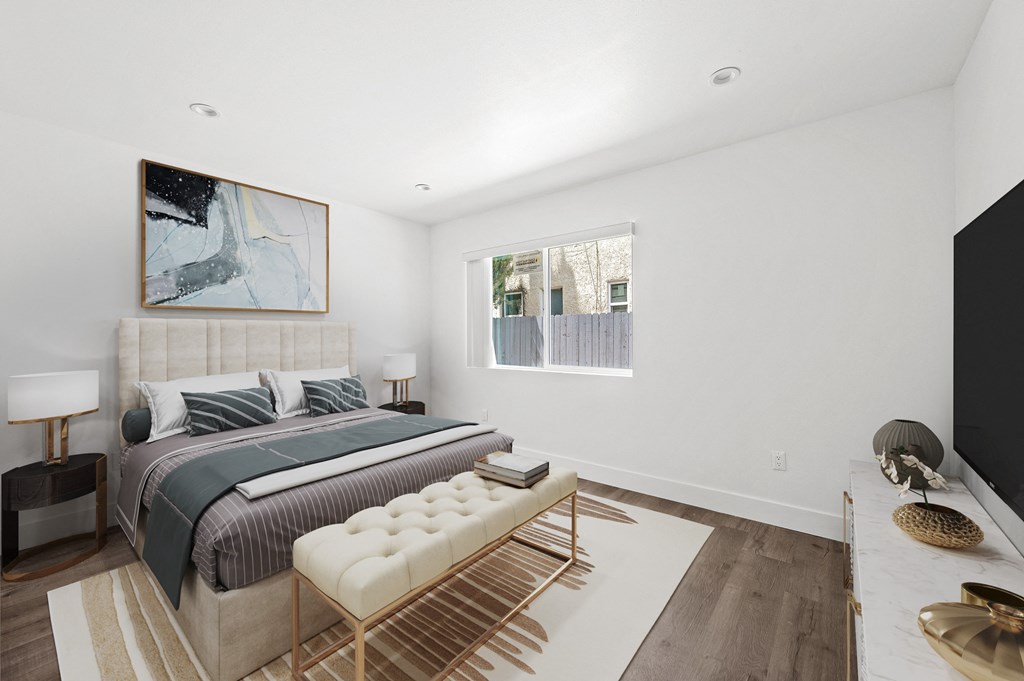 a bedroom with a large bed and a large window