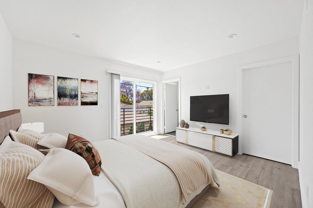 a bedroom with a large bed and a tv