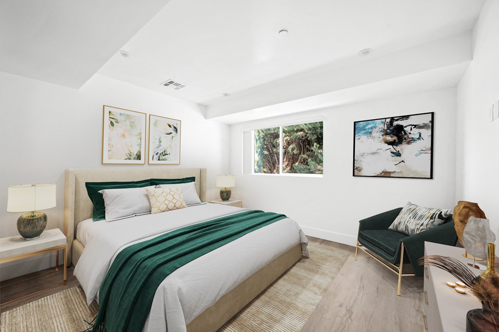 a bedroom with a bed and a couch and a window