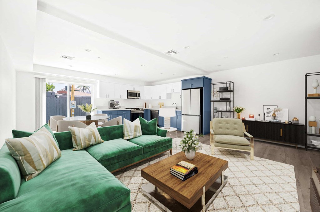 a living room with green couches and a coffee table