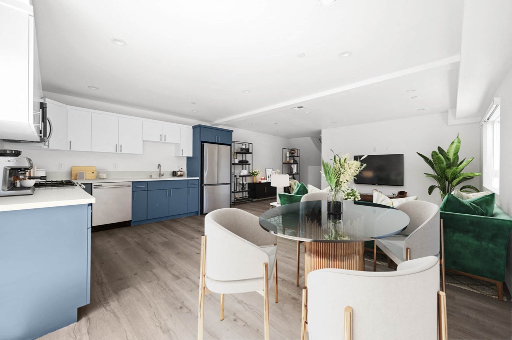 a living room and kitchen with blue cabinets and a table and chairs