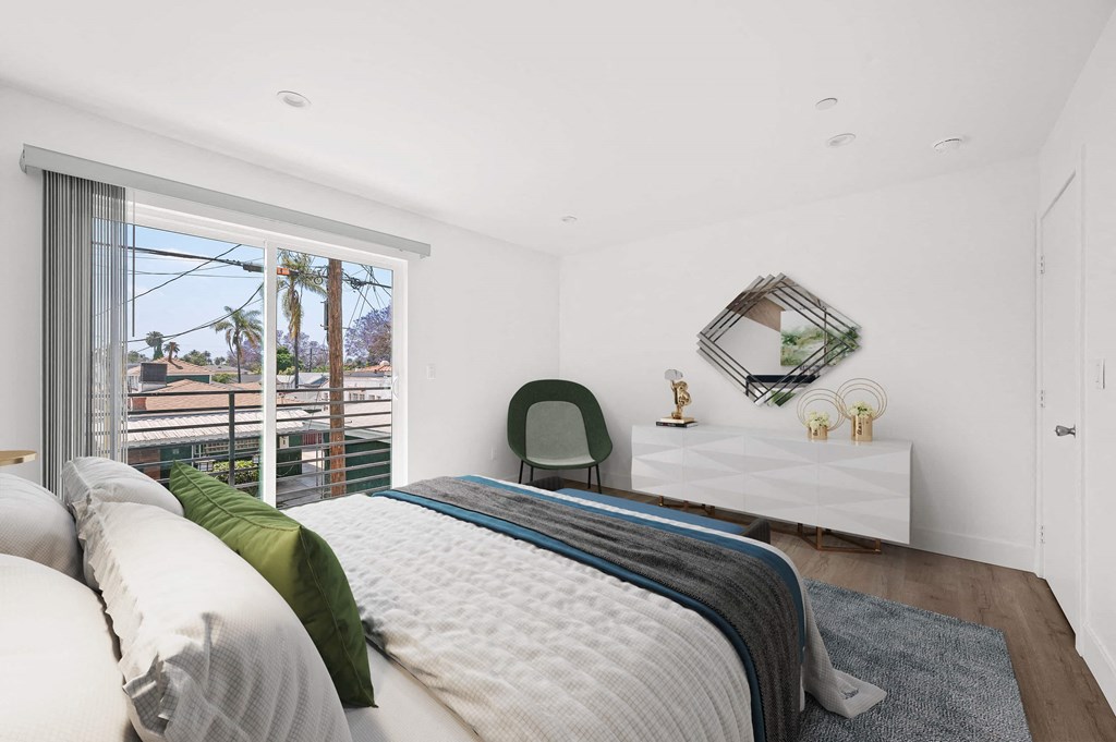 a bedroom with a bed and a large window