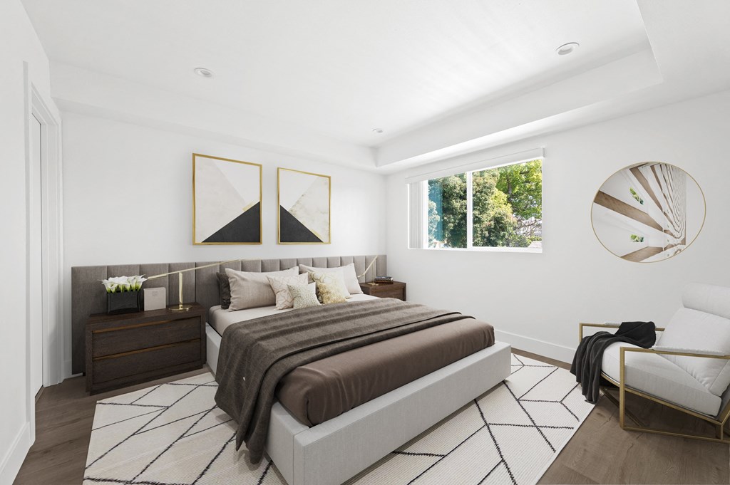 a bedroom with a bed and a large window