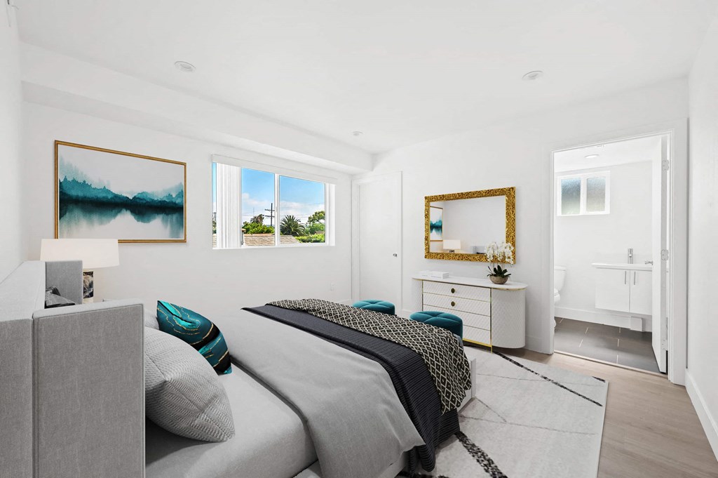 a bedroom with a bed and two windows