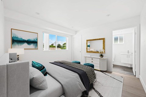 a bedroom with a bed and two windows