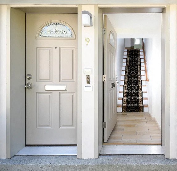 a white door and a staircase in a house