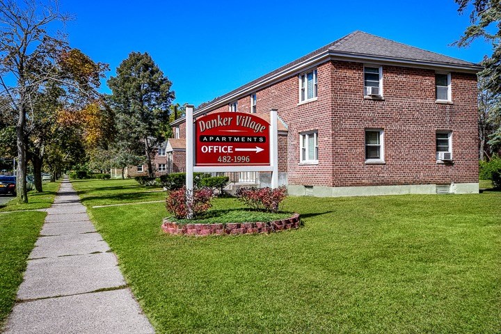 a sign in front of a brick building