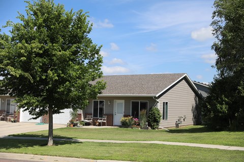 A house with a tree in front of it.