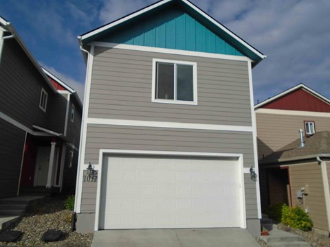 the front of a house with a garage door